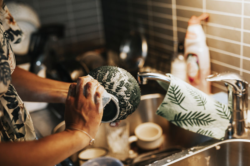 Woman's hands washing dishes