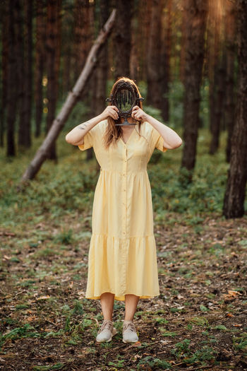 Woman with mirror instead of face on the forest background. mindfulness, mind and soul, mental