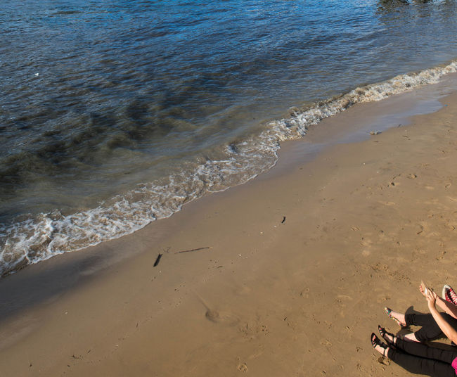 High angle view of woman relaxing on beach