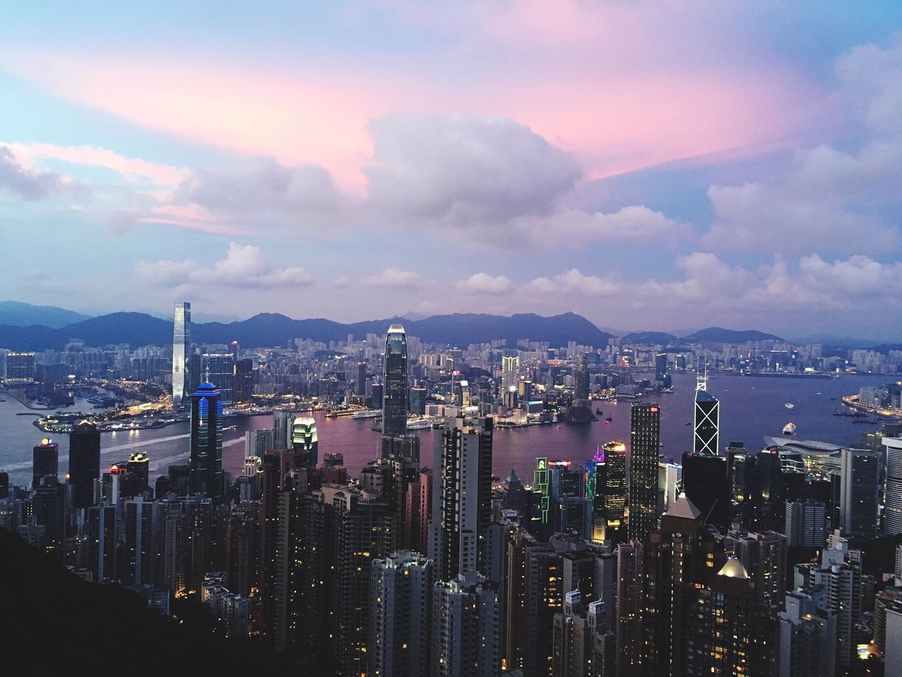 VIEW OF CITYSCAPE AGAINST CLOUDY SKY