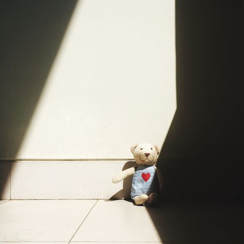 Cute teddy bear on floor at home