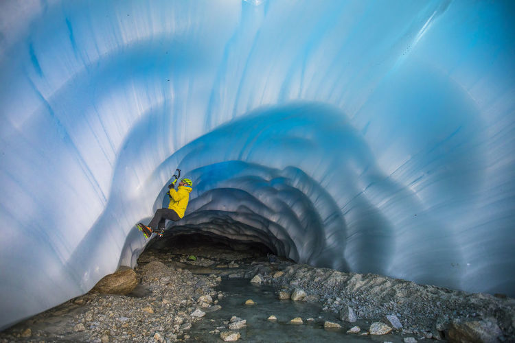 Ice climber climbing in glacial cave near vancouver.