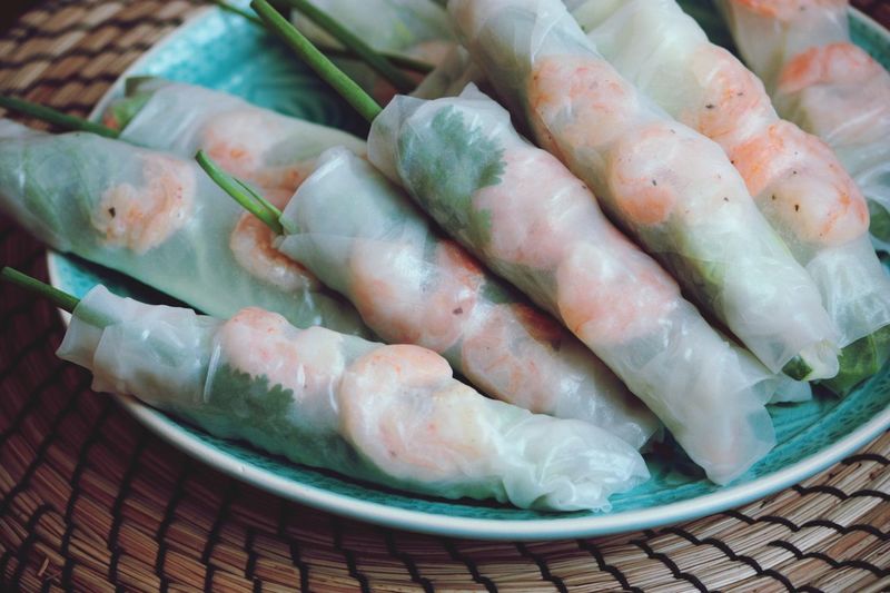 Close-up of uncooked spring rolls in plate