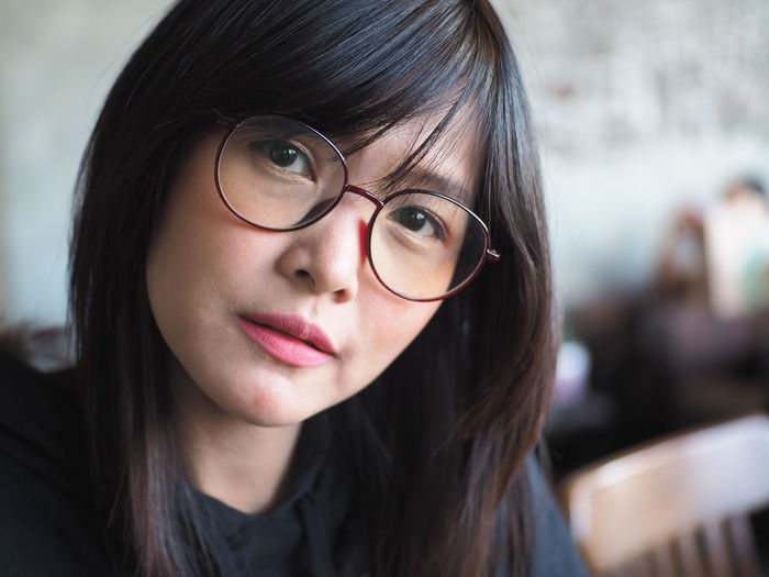 Close-up portrait of beautiful woman wearing eyeglasses