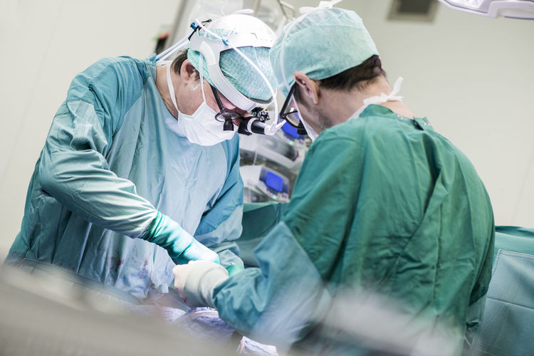 Heart surgeons during a heart valve operation