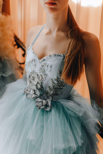 Female figure dressed in a festive blue princess dress