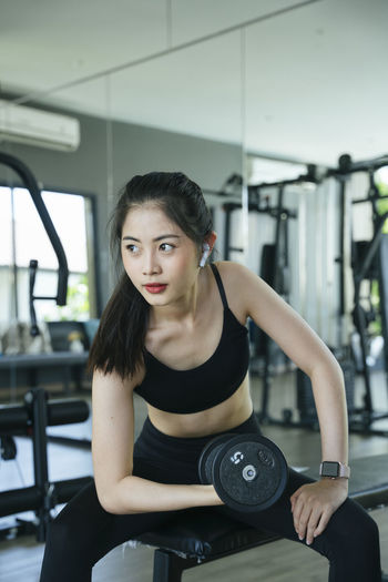 Beautiful young woman exercising at gym