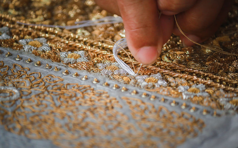Close-up of person sewing textile