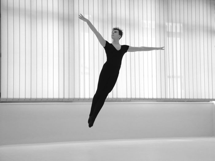 Full length of ballet dancer dancing in studio