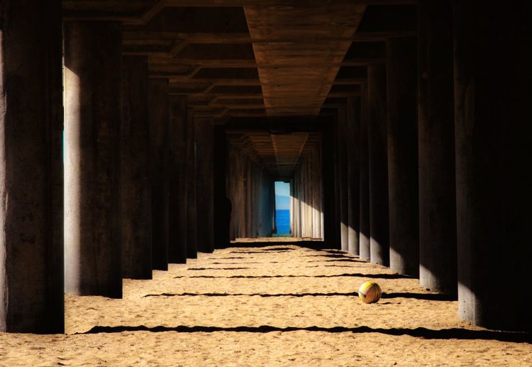 Volleyball ball below huntington beach pier on sand