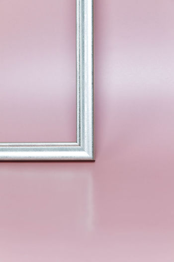 Frame on a pink background.  photograph of a window.