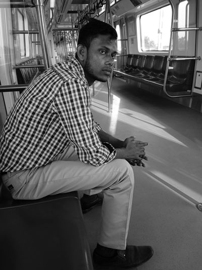 Side view of thoughtful man traveling in train