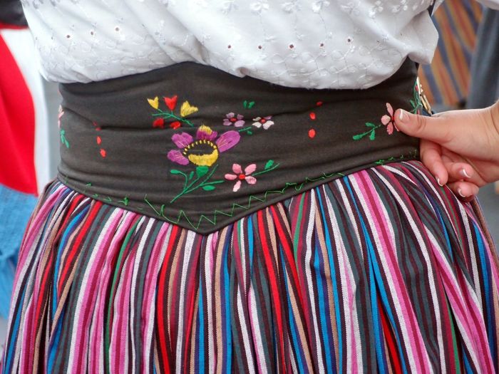Midsection of woman standing in traditional clothing