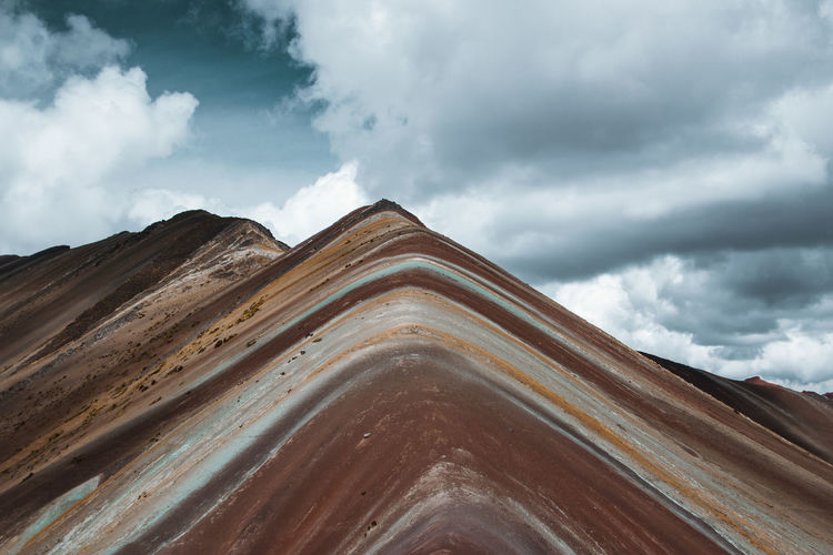 Low angle view of land against cloudy sky