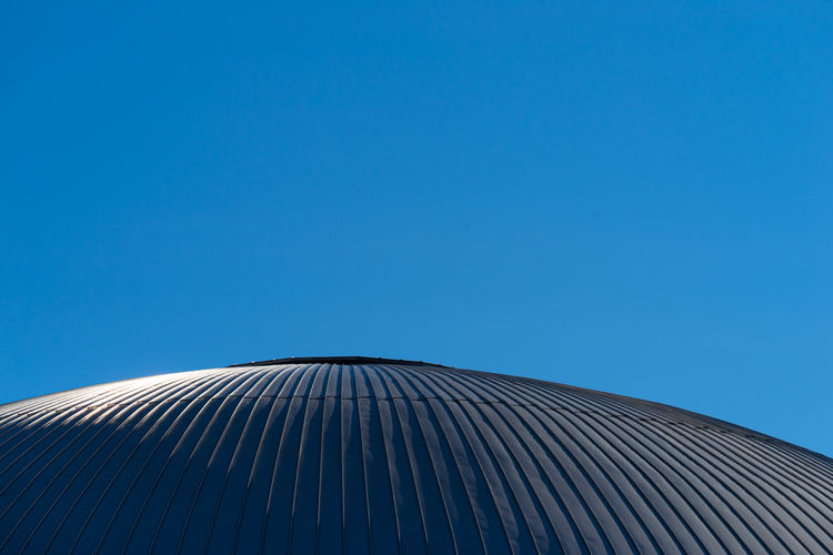 Low angle view roof toop of building against blue sky