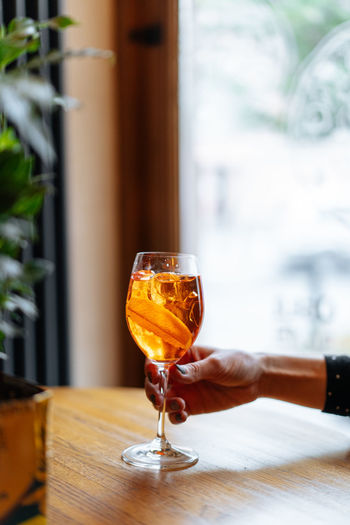 Spritz cocktail in female hand