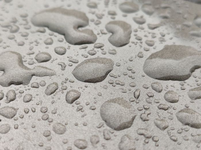 Full frame shot of raindrops on sand
