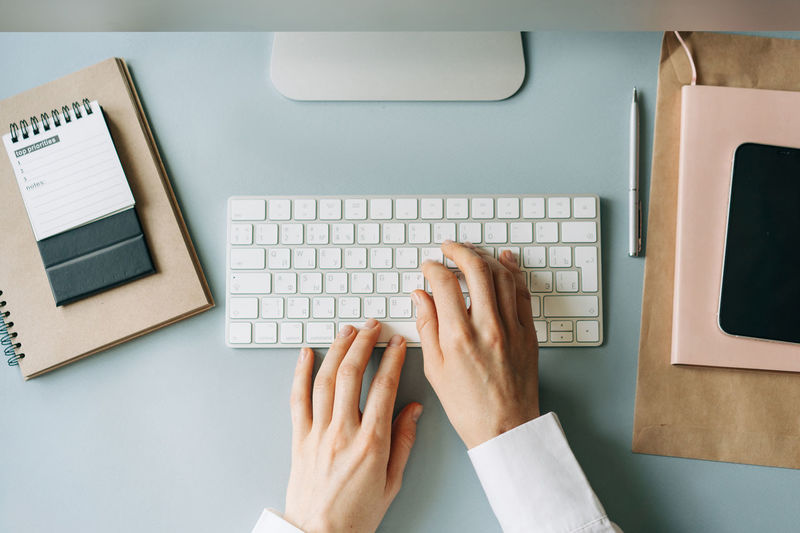 Cropped hands using laptop