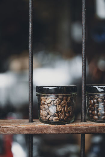 Close-up of coffee beans in jar on wood