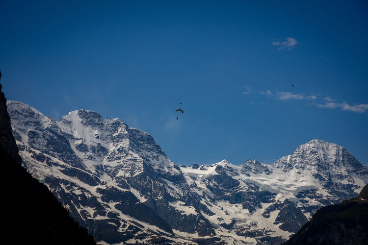 Low angle view of skydiver and mountains in the sky over lauterbrunnen valley.