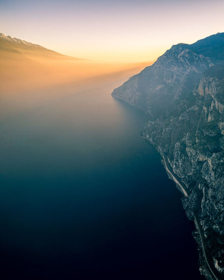 Aerial view of sea and mountains against sky