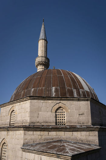 Low angle view of historic building against clear blue sky