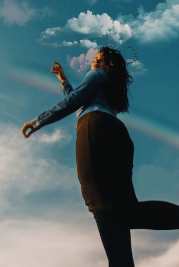Low angle view of woman playing against sky