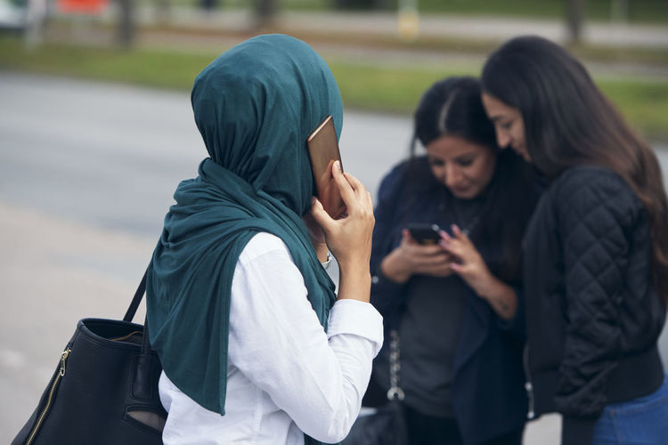 Women using mobile phone outdoors