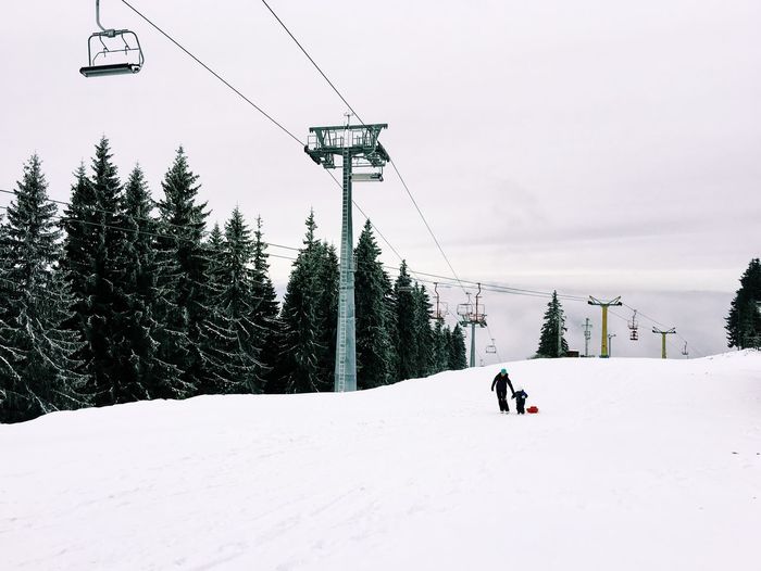 Ski lift on snow covered mountain