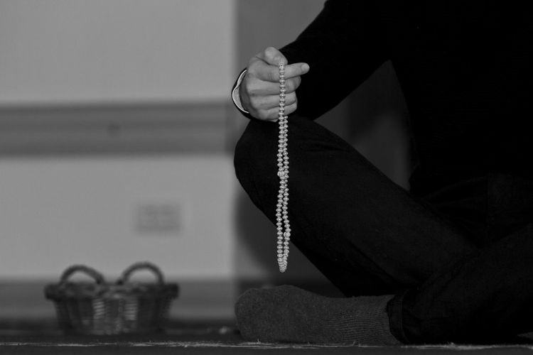 Close-up of hand holding beads