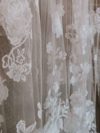 Close-up of clothes hanging on white curtain