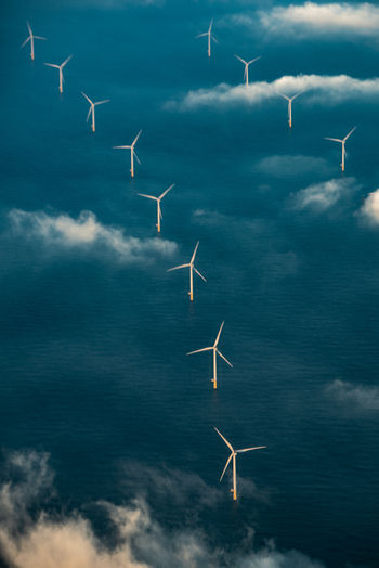 Aerial view of windmills on land