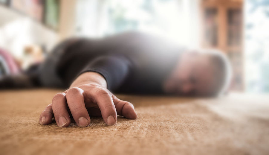 Close-up of man sleeping on floor