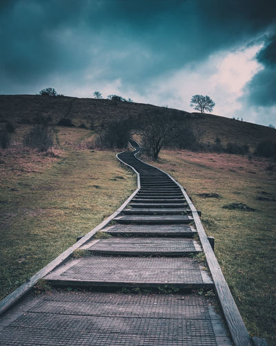 Wooden steps leading up st catherine's hill winchester, storm clouds over the hill 