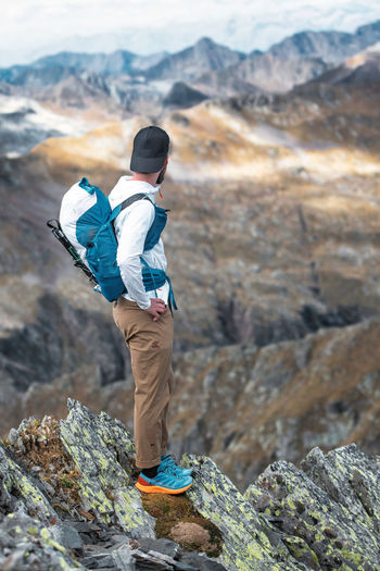 Man watches far away in the mountains in the italian alps
