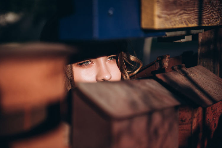 Close-up of young woman looking through mailbox