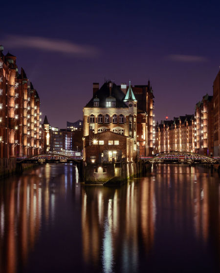 Reflection of buildings in water at night
