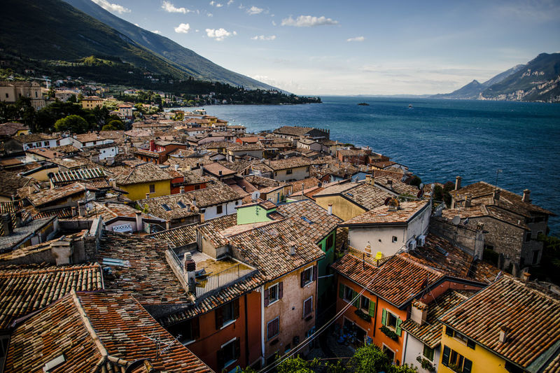 High angle view of townscape by sea against sky