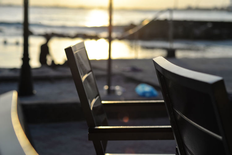 Close-up of chairs in sea