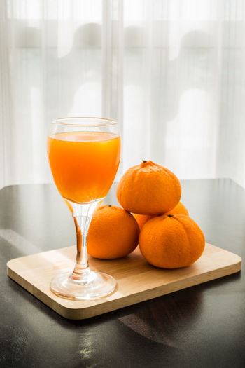 Close-up of orange juice in glass on table