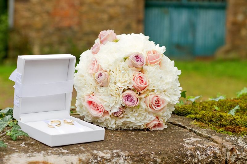 Rose bouquet by rings on retaining wall