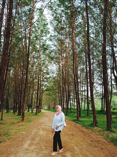 Man standing on field in forest
