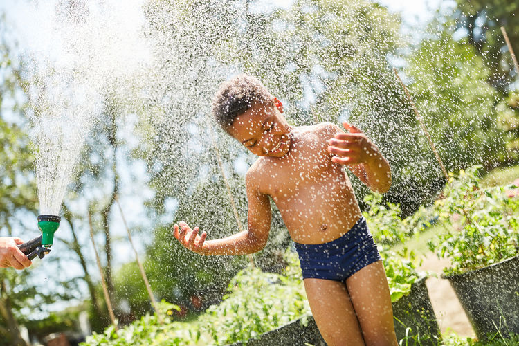 Boy enjoying water shower