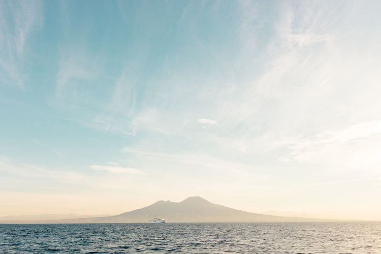 Scenic view of volcano vesuvio and sea against sky