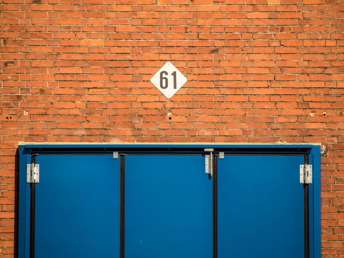 Arrow sign on brick wall