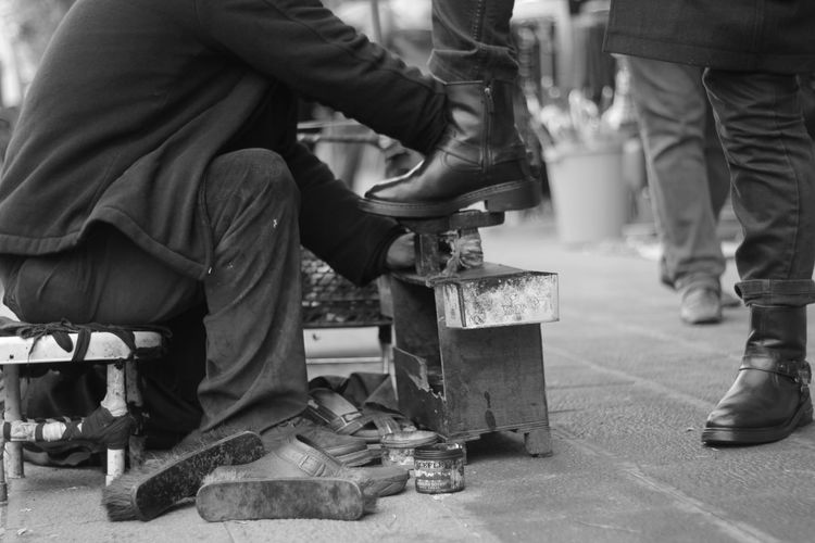 Low section of man polishing shoes