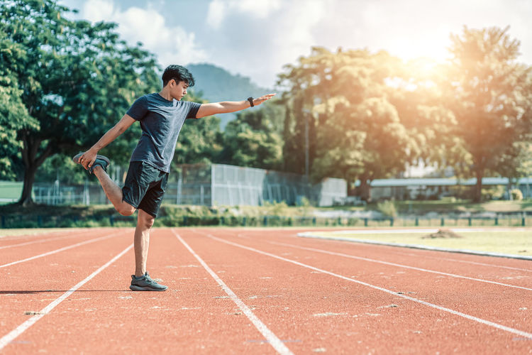 Full length of man exercising on track