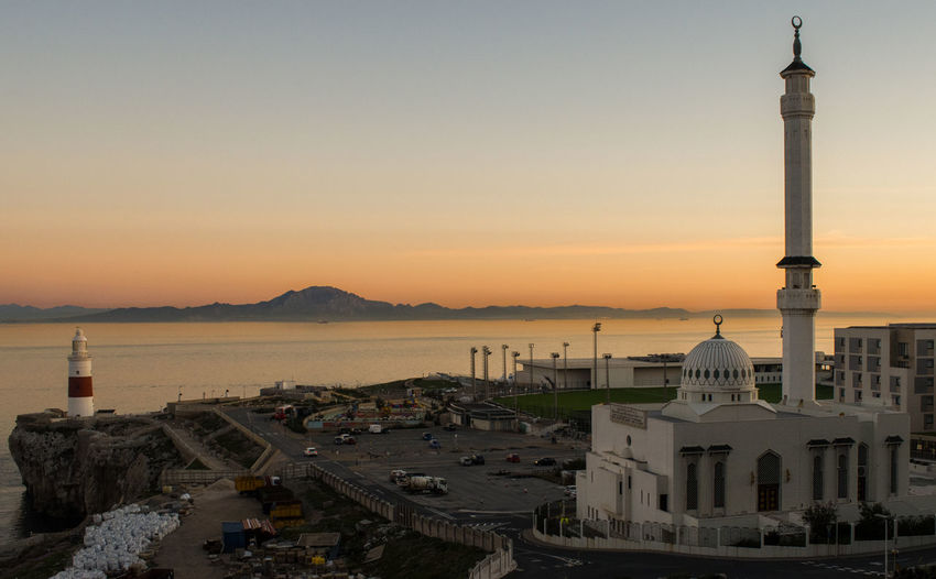 Sunset behind the light house and mosque in gibraltar 