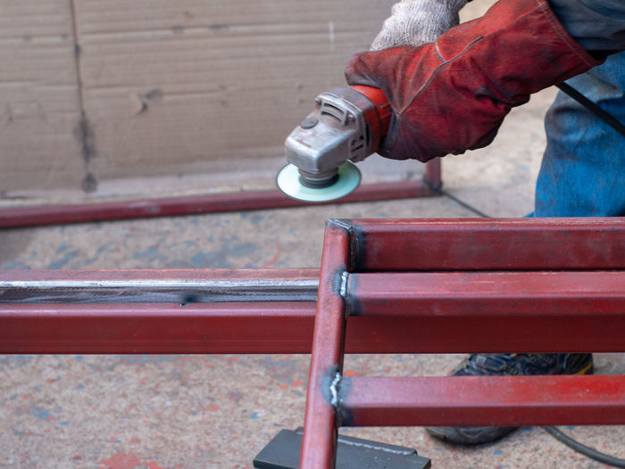 Low section of worker welding metal