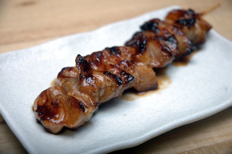 High angle view of skewered grilled meat in plate on table